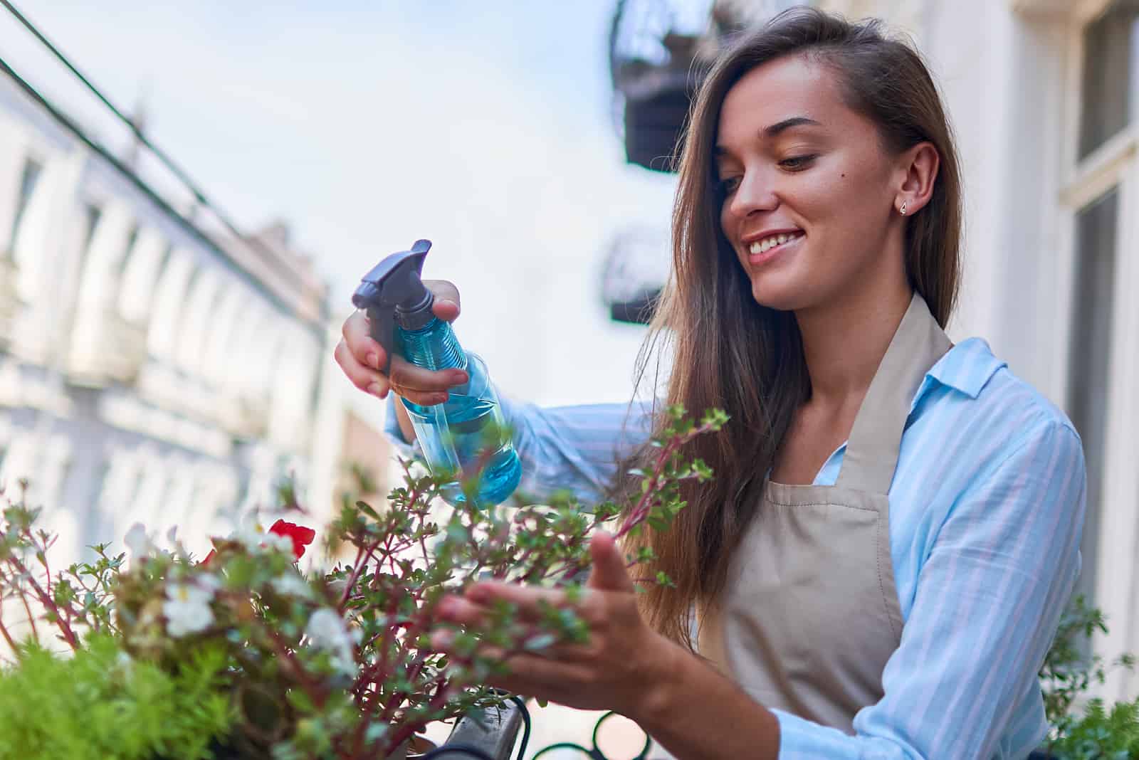 niña rociando flores